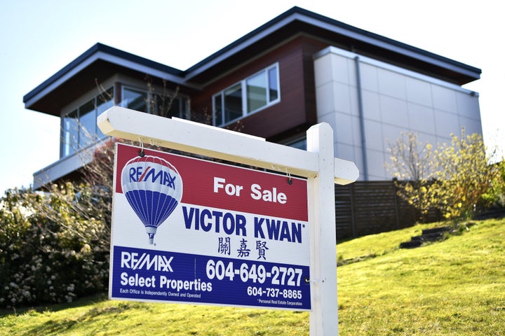 A real estate agent's for sale sign is seen here outside a detached home in Vancouver in April 2020. The Canadian Real Estate Association says home sales were up by 150 per cent compared to where they were in April.