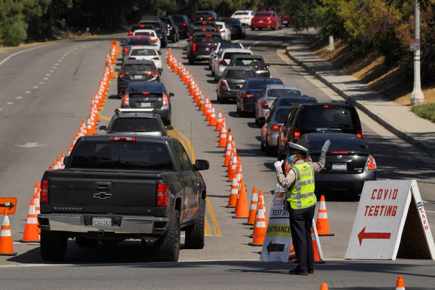 People wait in line for coronavirus testing at Dodger Stadium, July 14, in Los Angeles. (AP Photo/Mark J. Terrill)