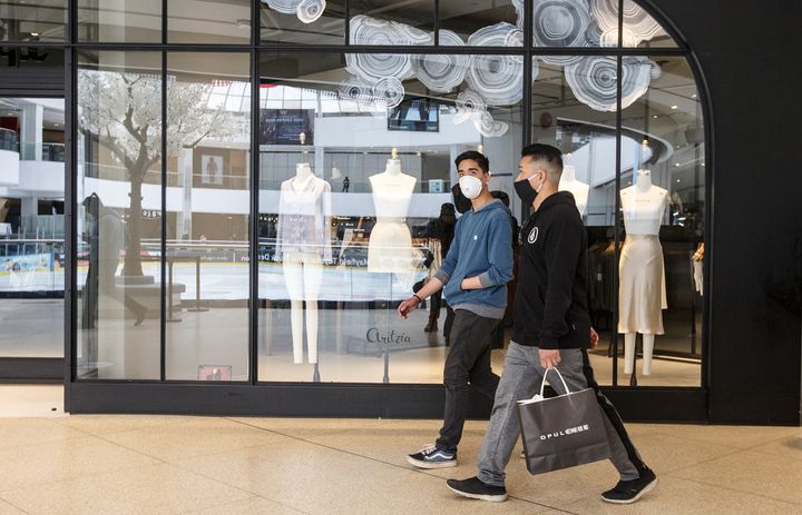 Shoppers walk past stores in West Edmonton Mall in Edmonton on May 14, 2020. 