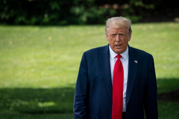 U.S. President Donald Trump exits the Oval Office and walks toward Marine One on the South Lawn of the...