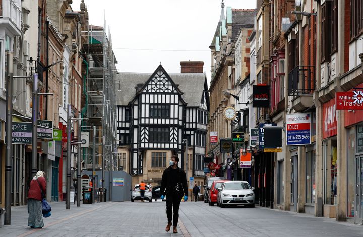 A man walks down a near empty shopping street in Leicester, England, on July 1, 2020. Leicester became the first British city to be put into regional lockdown at the end of June.