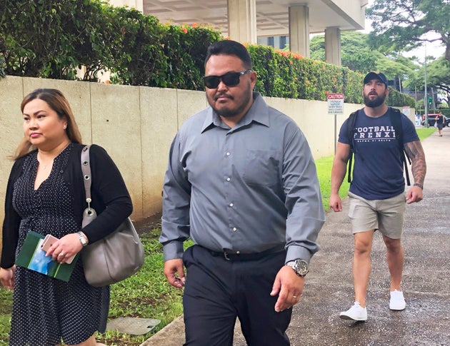 Former Honolulu police officer Reginald Ramones, seen center last September, is scheduled to be sentenced next week. Ramones pleaded guilty to knowing Rabago committed a civil rights violation and not informing authorities about it.