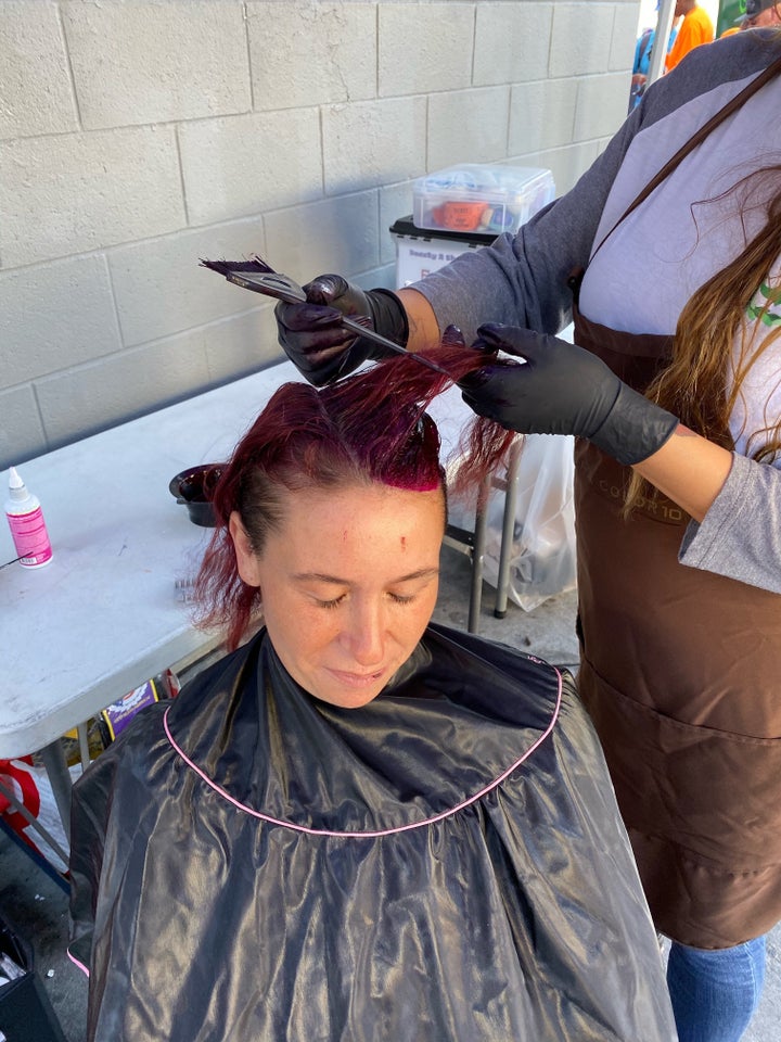 A woman gets her hair dyed during a visit from Beauty2theStreetz volunteers.