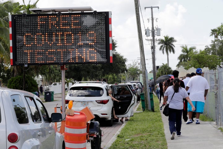 People wait in line outside of a COVID-19 testing site during the coronavirus pandemic on July 16 in Opa-locka, Florida.