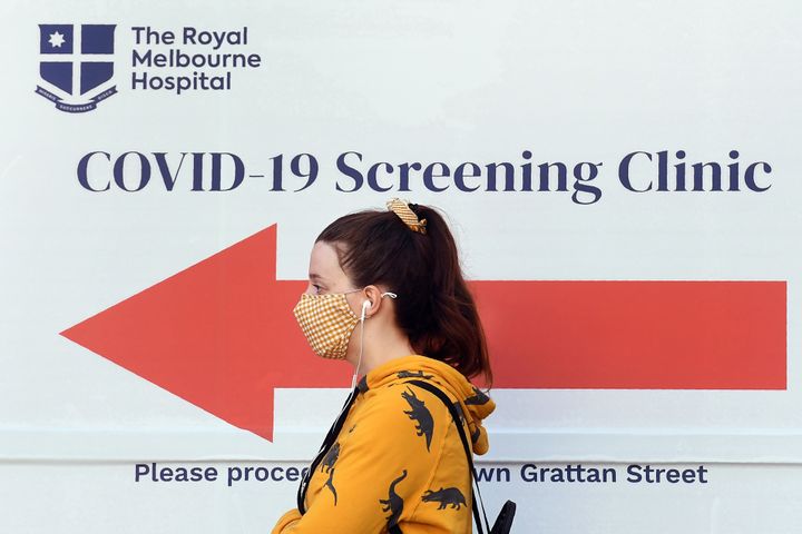 A woman queues outside a COVID-19 coronavirus testing venue Thursday at The Royal Melbourne Hospital in Melbourne.