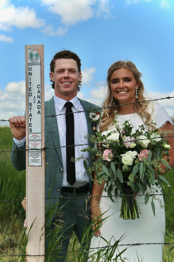 Newlyweds Jaxson (left) and Kadee pose at the Canada-U.S. border where they got married.