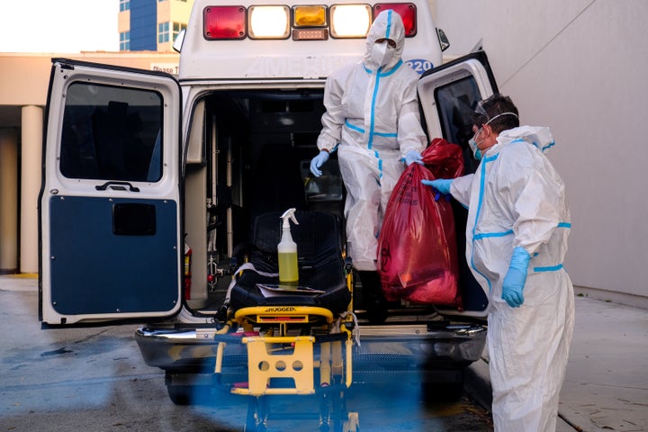 EMTs cleanse their materials outside Memorial West Hospital where coronavirus disease (Covid-19) patients are treated, in Pembroke Pines, Florida, July 13, 2020. REUTERS/Maria Alejandra Cardona TPX IMAGES OF THE DAY