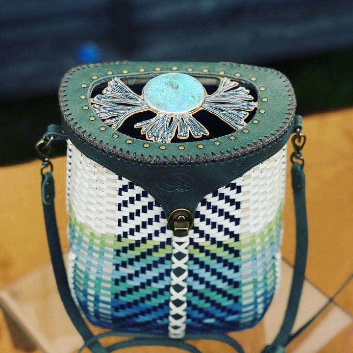 Indigo, lockwood and osage-dyed purse with bronze and silver inlay on a custom leather lid. Made in collaboration with jeweler <a href="https://www.instagram.com/nisajewelry/?hl=en" role="link" class=" js-entry-link cet-external-link" data-vars-item-name="Nisa Smiley" data-vars-item-type="text" data-vars-unit-name="5f11d1f4c5b619afc400ea87" data-vars-unit-type="buzz_body" data-vars-target-content-id="https://www.instagram.com/nisajewelry/?hl=en" data-vars-target-content-type="url" data-vars-type="web_external_link" data-vars-subunit-name="article_body" data-vars-subunit-type="component" data-vars-position-in-subunit="31">Nisa Smiley</a>. $1,800.
