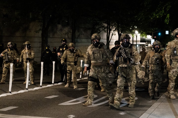 Federal officers prepare to disperse the crowd of protestors in Portland.
