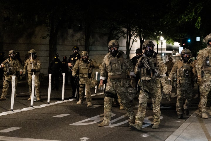 Federal officers prepare to disperse the crowd of protestors in Portland. 