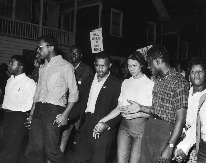 Civil Rights leaders, including future Congressman John Lewis (third left) and Gloria Richardson (third right), chair of the Cambridge Non-Violent Action Committee, links hands with others as they march in protest of a scheduled speech by the pro-segregationist Alabama governor, George Wallace, Cambridge, Maryland, May 1964. (Photo by Francis Miller/The LIFE Picture Collection via Getty Images)