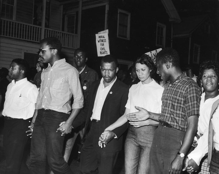 Civil Rights leaders, including future Congressman John Lewis (third left) and Gloria Richardson (third right), chair of the Cambridge Non-Violent Action Committee, links hands with others as they march in protest of a scheduled speech by the pro-segregationist Alabama governor, George Wallace, Cambridge, Maryland, May 1964. (Photo by Francis Miller/The LIFE Picture Collection via Getty Images)