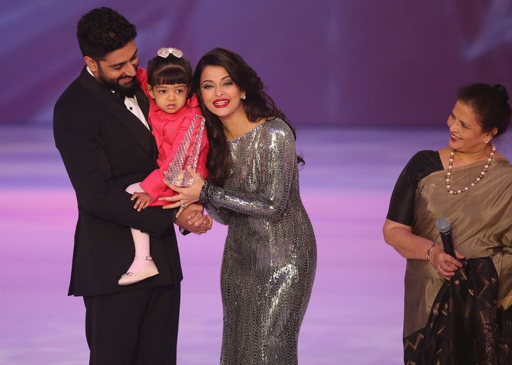 Former Miss World Aishwarya Rai, centre speaks on stage with husband Abhishek Bachchan and daughter Aaradhya Bachchan, during the Miss World 2014 final, on Dec. 14, 2014.