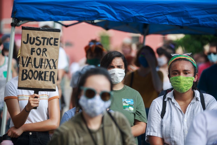 A protester holds a placard that says Justice for Vauhxx Booker during a community protest against racism on July 6. 