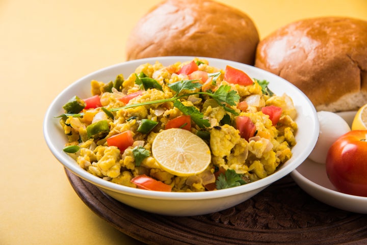 Masala Anda Bhurji of egg bhurji or Spicy scrambled eggs with bread or pav or paav slices and salade, anda bhurji paav