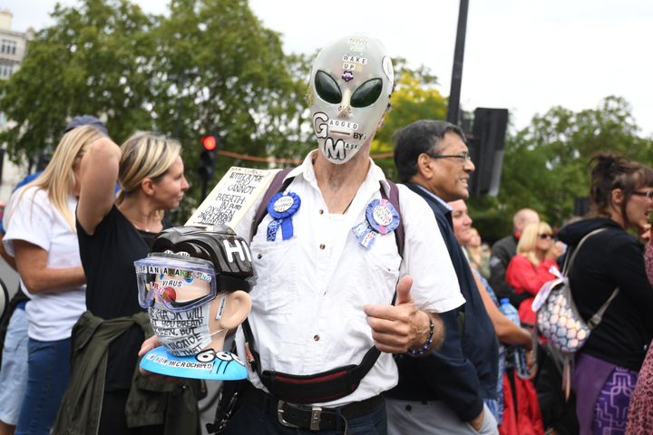 People attend a protest against the wearing of masks during the coronavirus outbreak, in Hyde Park, London.