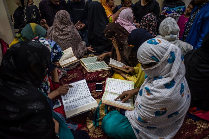 Indian Muslim women riot survivor recite holy Quran as they seek shelter in a makeshift camp, in a riot-affected area on March 01, 2020 in New Delhi. 