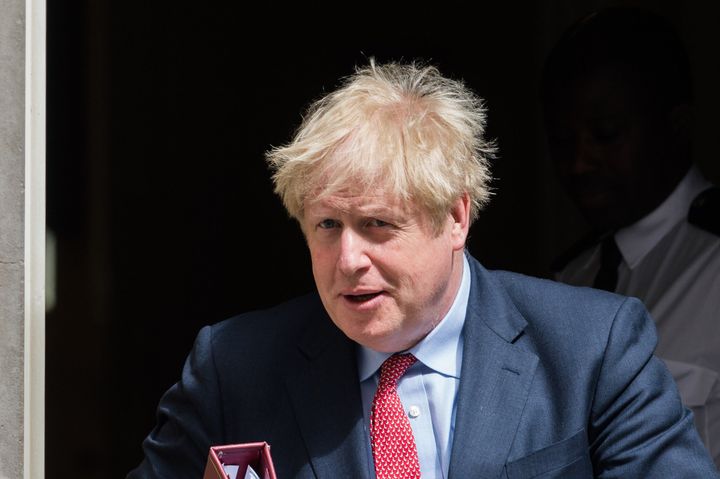 U.K. Prime Minister Boris Johnson leaves 10 Downing Street on July 15, 2020. On Friday, Johnson suggested that coronavirus restrictions could largely be gone by Christmas.