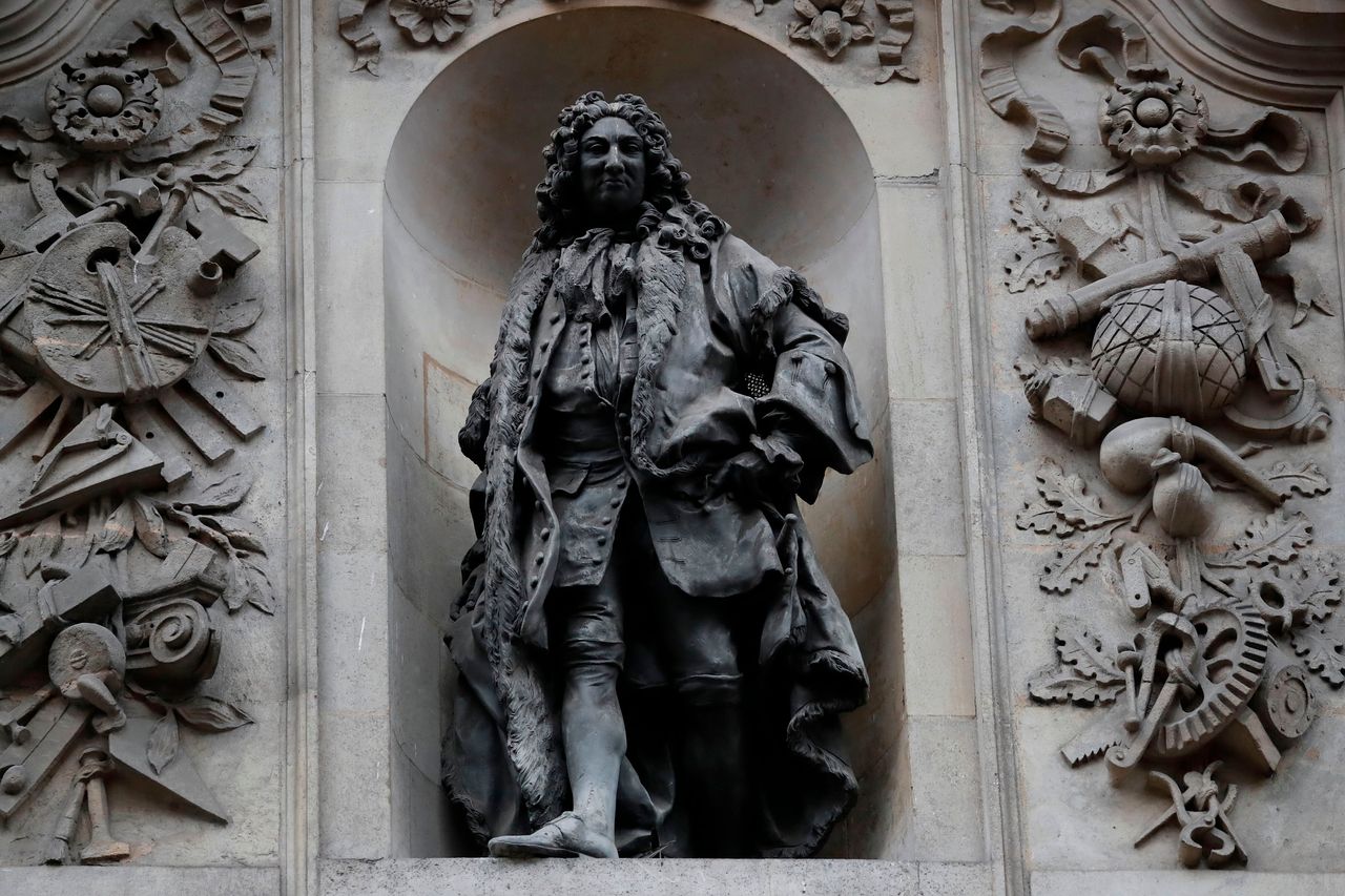 A statue of English merchant and slave trader Sir John Cass is mounted on the wall of the Sir John Cass Foundation in central London