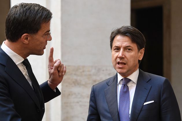 Italy's Prime Minister Giuseppe Conte (R) talks with his Dutch counterpart Mark Rutte upon his arrival...
