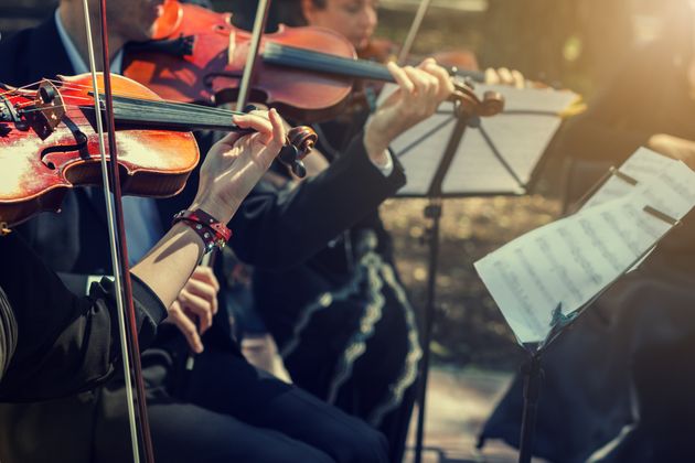 Musicians playing the violin close up.