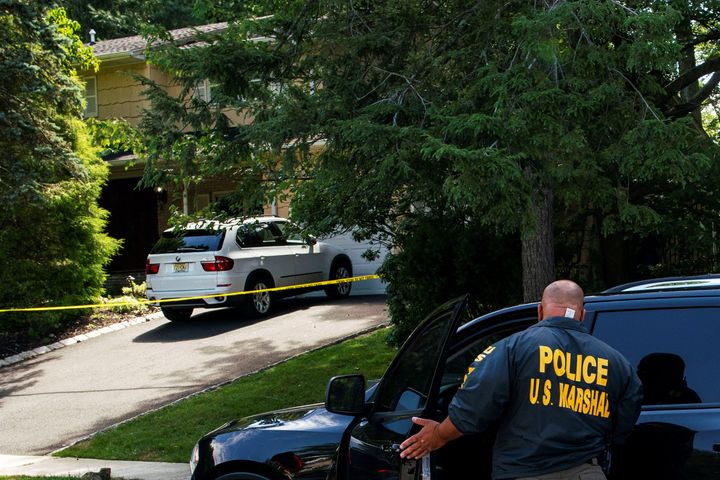 Law enforcement officials are seen July 20 outside the home of U.S. District Judge Esther Salas, where her son was killed and husband critically injured, in North Brunswick, New Jersey.