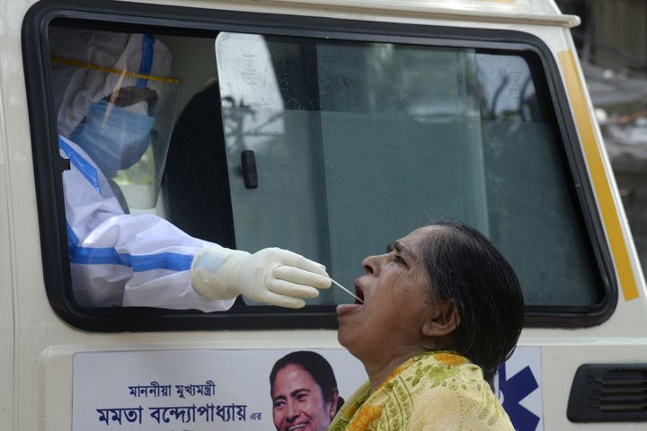 A health worker collects swab samples for Covid-19 testing at a mobile collection van in West Bengal. 