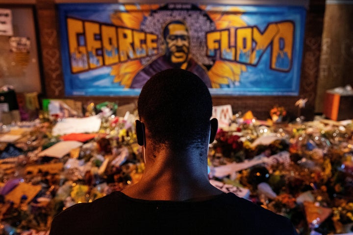 A man recites spoken word poetry at a makeshift memorial honoring George Floyd, at the spot where he was taken into custody,