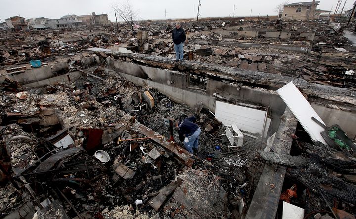 A man stands by the remains of his home in Breezy Point, Queens, after Superstorm Sandy pummeled New York City in 2012.