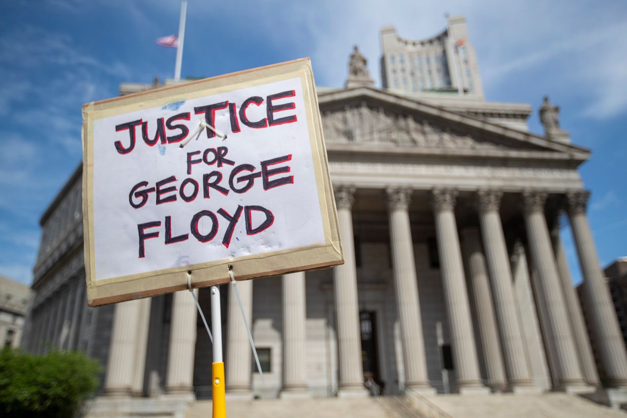 A protester holds a sign in front of New York Supreme Court on May 29 demanding justice for George Floyd, a handcuffed black man who died Memorial Day in Minneapolis police custody.