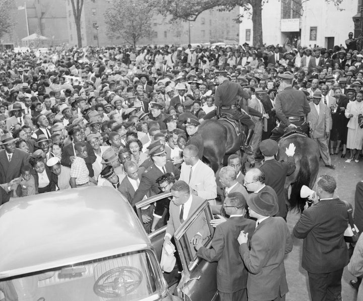 People in New York gather around Mamie Bradley, the mother of Emmett Till, to protest the acquittal of her son's murderers in Mississippi.