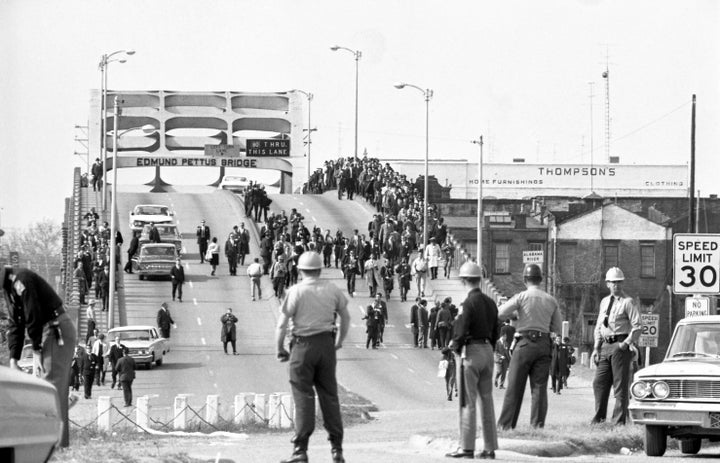Demonstrators march across the Edmund Pettus Bridge in Selma, Alabama, on March 9, 1965, just two days after the violent back