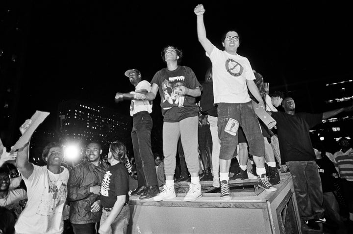 People in Los Angeles overturn a parking kiosk and set it on fire in protest of the acquittal of the LAPD officers who beat Rodney King.