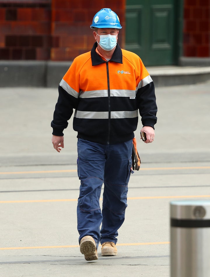 A construction worker is seen wearing a face mask on July 22, 2020 in Melbourne, Australia. Face masks or coverings are mandatory from Thursday 23 July, with $200 fines to apply for not wearing face coverings.