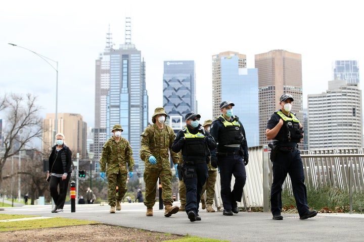 Police and the Australian military patrol the banks of the Yarra River on July 23, 2020 in Melbourne, Australia. Face masks or face coverings are now mandatory for anyone leaving their homes in the Melbourne metropolitan area or the Mitchell Shire.