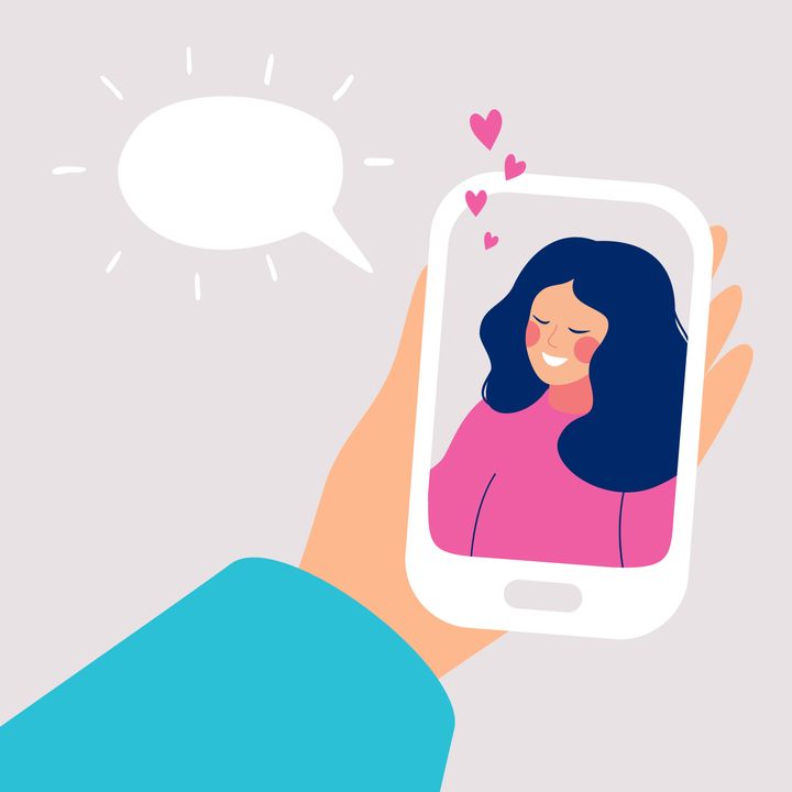 Human hand holds mobile smartphone with smiling young woman on display. Speech bubble above. Vector cartoon illustration of phone conversation
