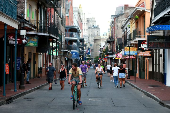 Pedestrians walk along Bourbon Street in New Orleans on July 14. Louisiana Gov. John Bel Edwards allowed bars to reopen at reduced capacity in June, then reimposed restrictions due to rising coronavirus caseloads.