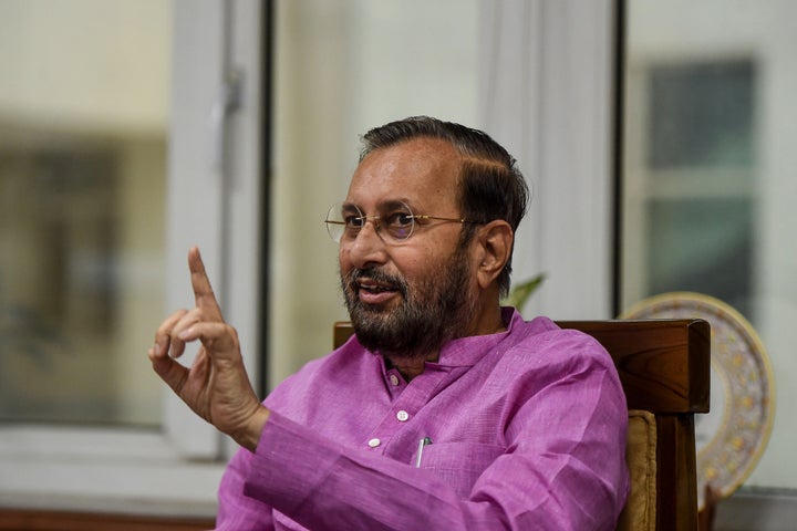 Prakash Javadekar, Indian Minister of Environment, Forests and Climate Change, Minister of Information and Broadcasting and Minister of Heavy Industries and Public Enterprises, gestures as he speaks with media representatives at his office in New Delhi.