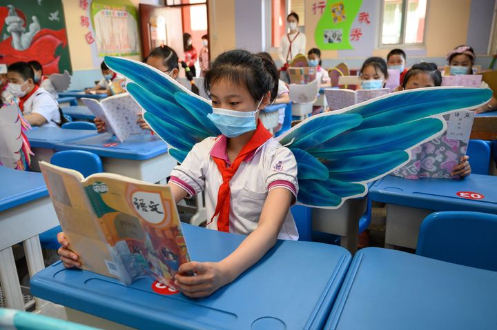Elementary school students wear wings to maintain social distance in Taiyuan, China.&nbsp