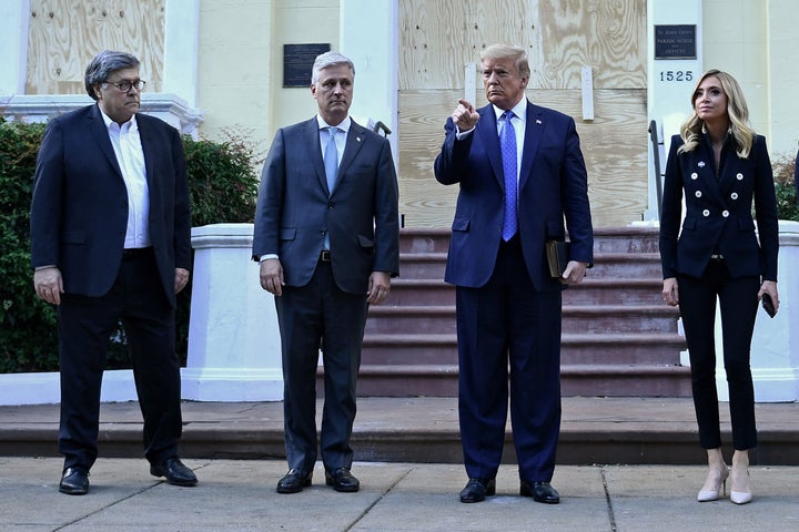 President Donald Trump holds up a Bible alongside Attorney General William Barr (left), White House national security adviser Robert O’Brien and White House press secretary Kayleigh McEnany, outside of St. John's Episcopal Church across Lafayette Park in Washington, D.C., on June 1.