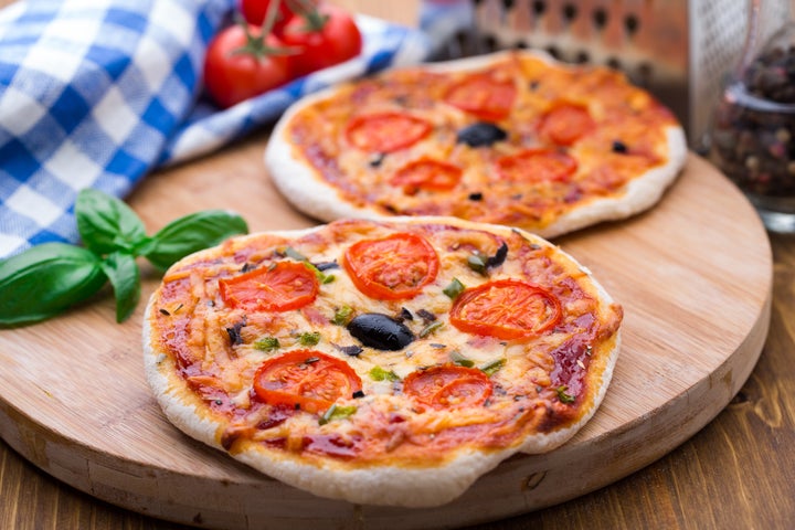 Vegetarian mini pizza with cherry tomatoes, paprika and olives