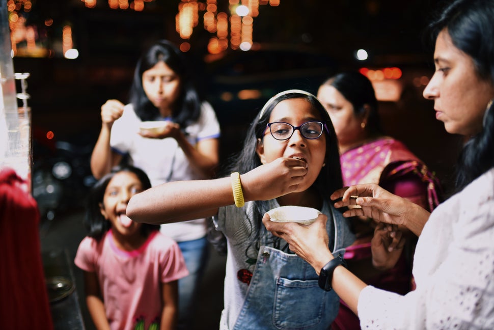 Family members eating street food in the night