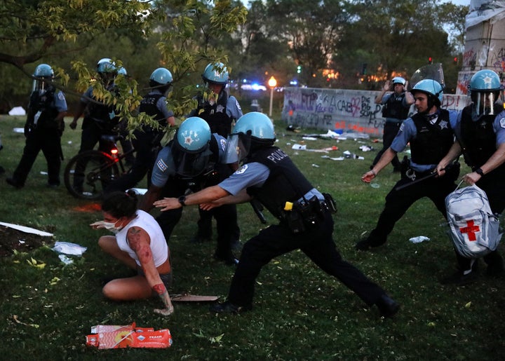 A protester and Chicago police clash after protesters tried to topple the Christopher Columbus statue in Grant Park during a rally on July 17, 2020. (Chris Sweda/Chicago Tribune/Tribune News Service via Getty Images)