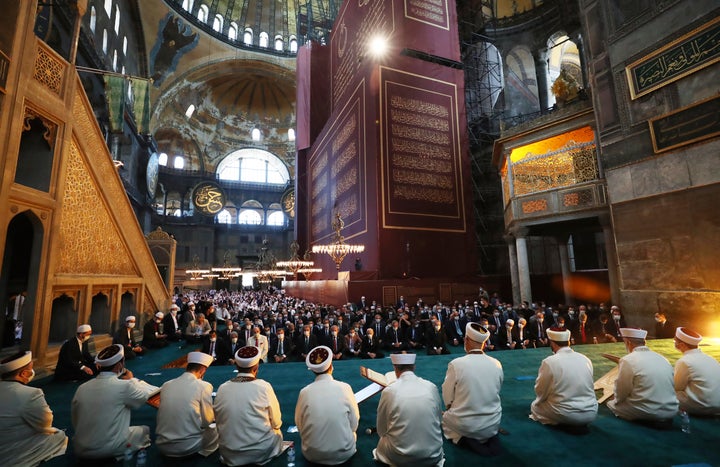 Imams read sermons as Friday as dignitaries, including Turkey's President Recep Tayyip Erdogan, take part in Friday prayers at the Hagia Sophia on July 24, 2020.