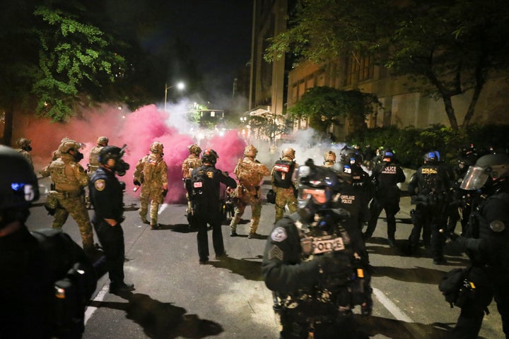 Police respond to protesters during a demonstration July 17 in Portland, Oregon. Militarized federal agents deployed by the president fired tear gas against protesters again overnight as the city’s mayor demanded that the agents be removed.