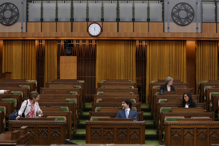 Prime Minister Justin Trudeau speaks with Deputy Prime Minister Chrystia Freeland during a Special Committee on the COVID-19 pandemic in the House of Commons on Parliament Hill on May 13, 2020 in Ottawa
