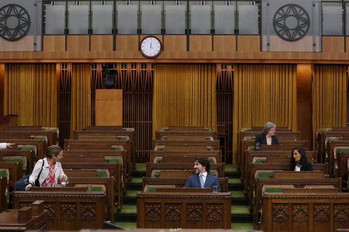 Prime Minister Justin Trudeau speaks with Deputy Prime Minister Chrystia Freeland during a Special Committee on the COVID-19 pandemic in the House of Commons on Parliament Hill on May 13, 2020 in Ottawa