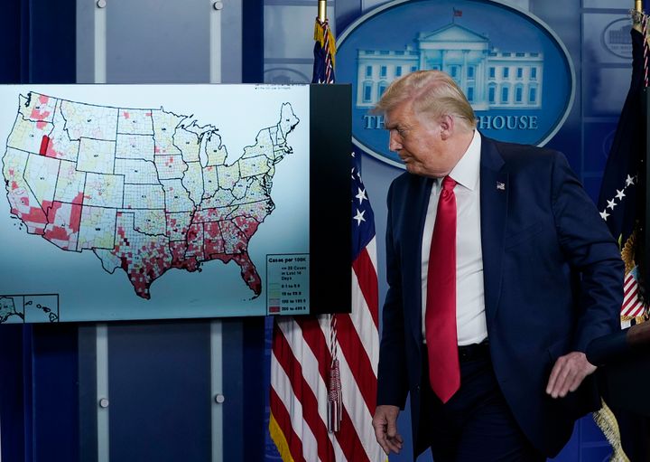 President Donald Trump, who previously told the country that the coronavirus would disappear “like a miracle,” stands next to a map of his miracle on July 23.