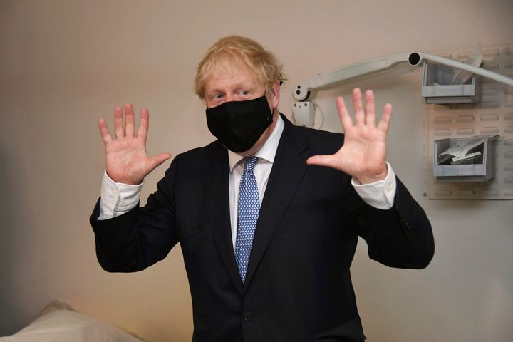 Boris Johnson gestures during a visit to Tollgate Medical Centre in Beckton, East London.