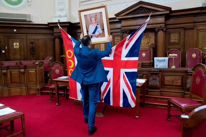 A registrar, Dion Goncalves sets up a citizenship ceremony at Islington Town Hall